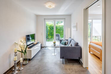 Modern new-construction apartment with a sunny terrace and garden