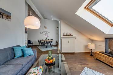 Cozy attic apartment surrounded by greenery