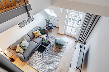 The photo shows a living room inside a house, the photo is taken from high up