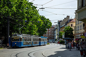 The photo shows a streetcar driving through the Haidhausen district