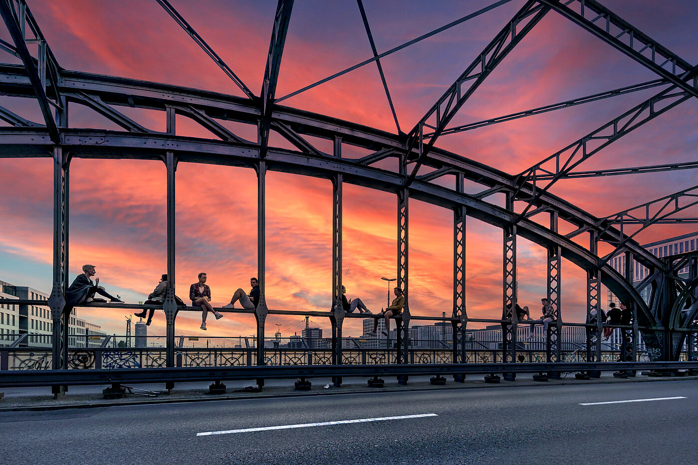 You can see the Hackerbrücke where numerous people are sitting watching the sunset