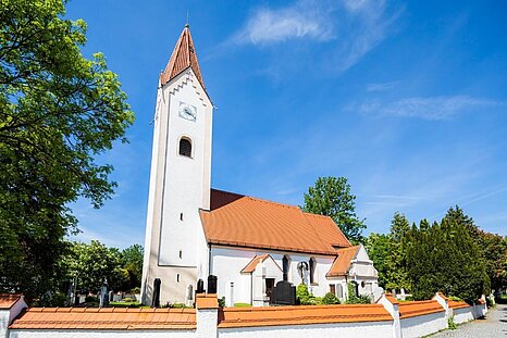 The photo shows a church with a blue sky in the background