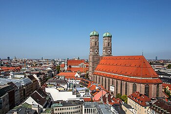 The photo shows the Munich skyline with the Frauenkirche right of center